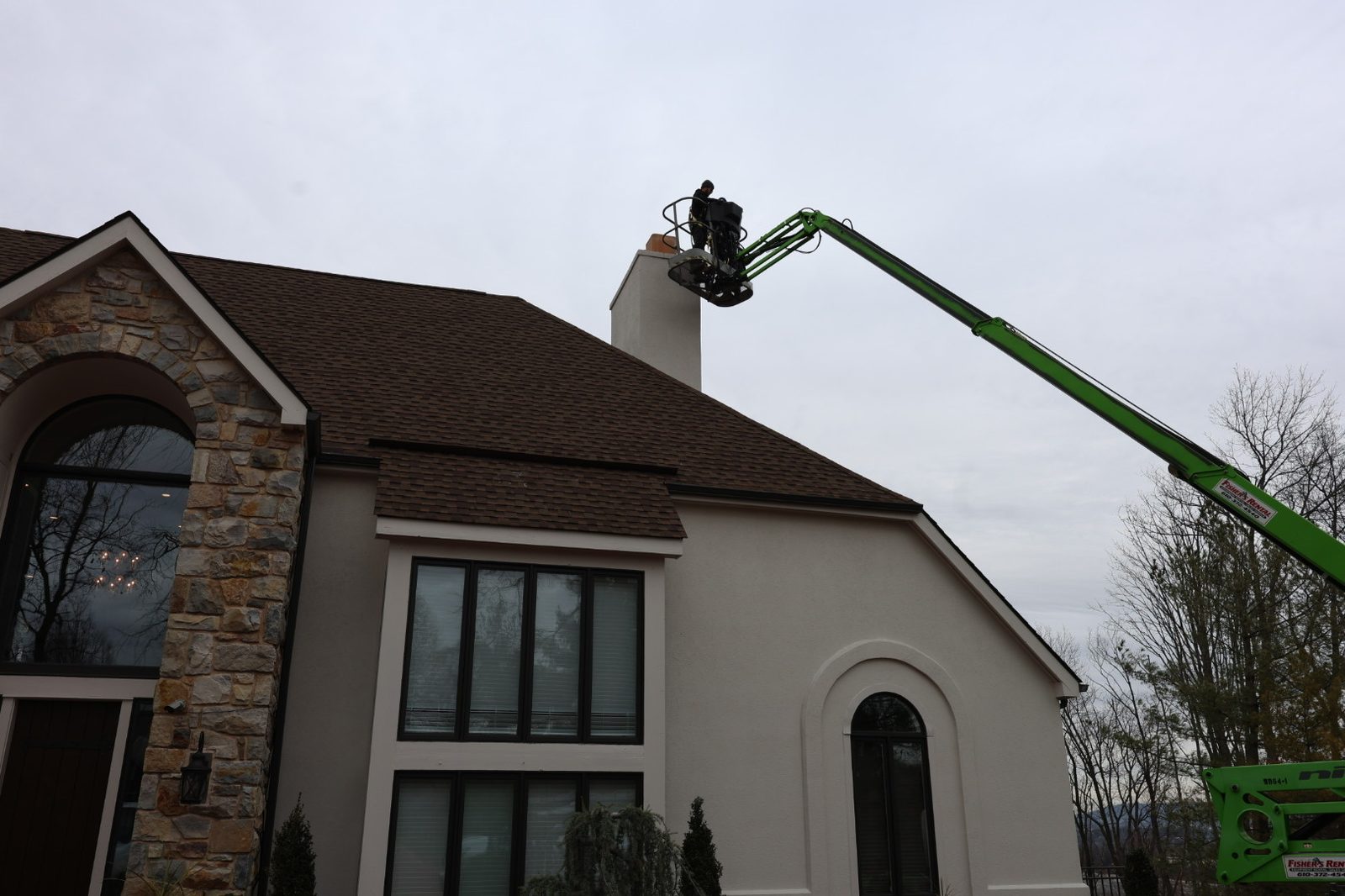 Boom lift positioned for roof work on a stucco home in Sinking Spring, PA