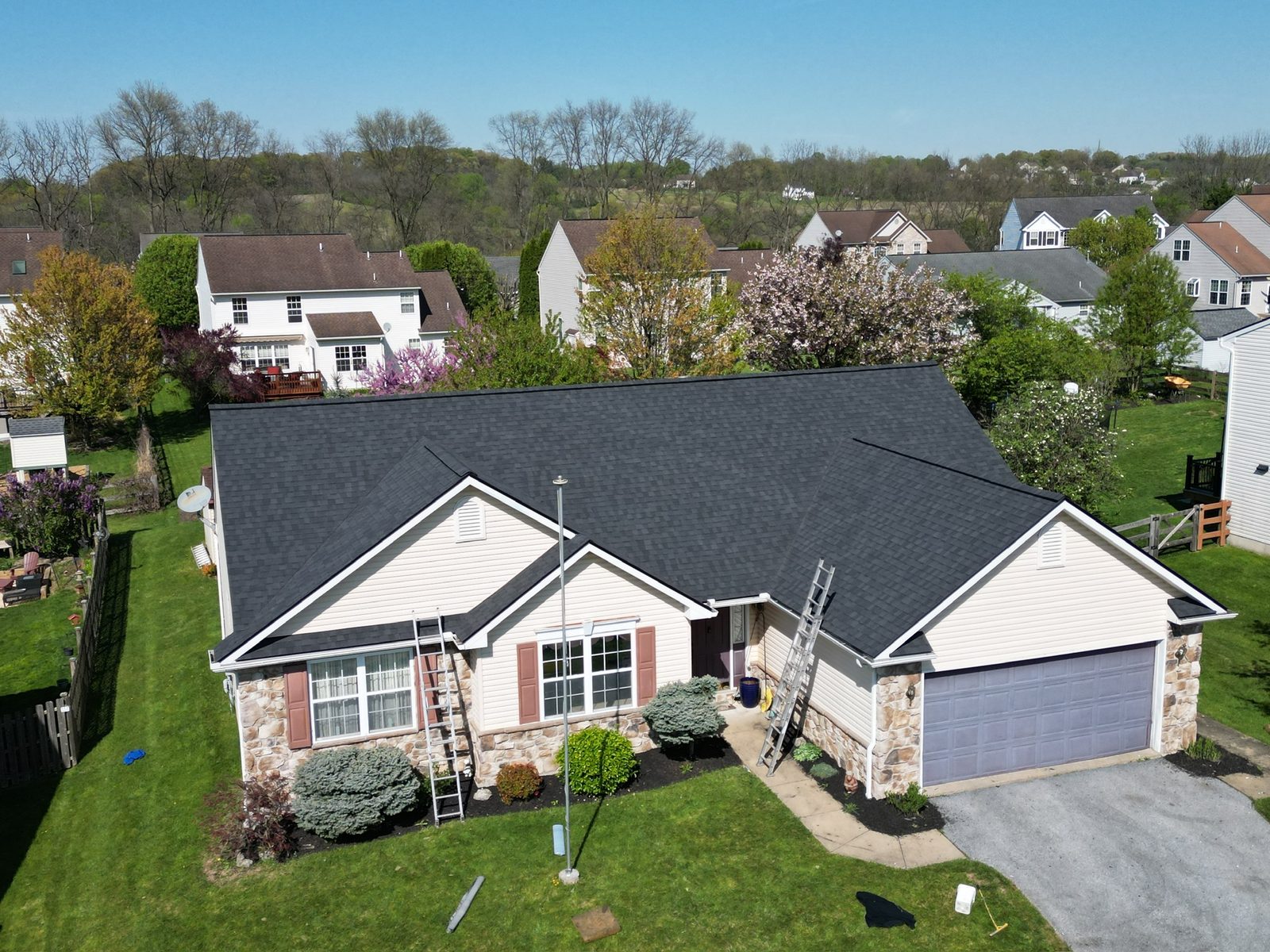 Drone view of a ranch home with a new gray shingle roof in Wernersville, PA
