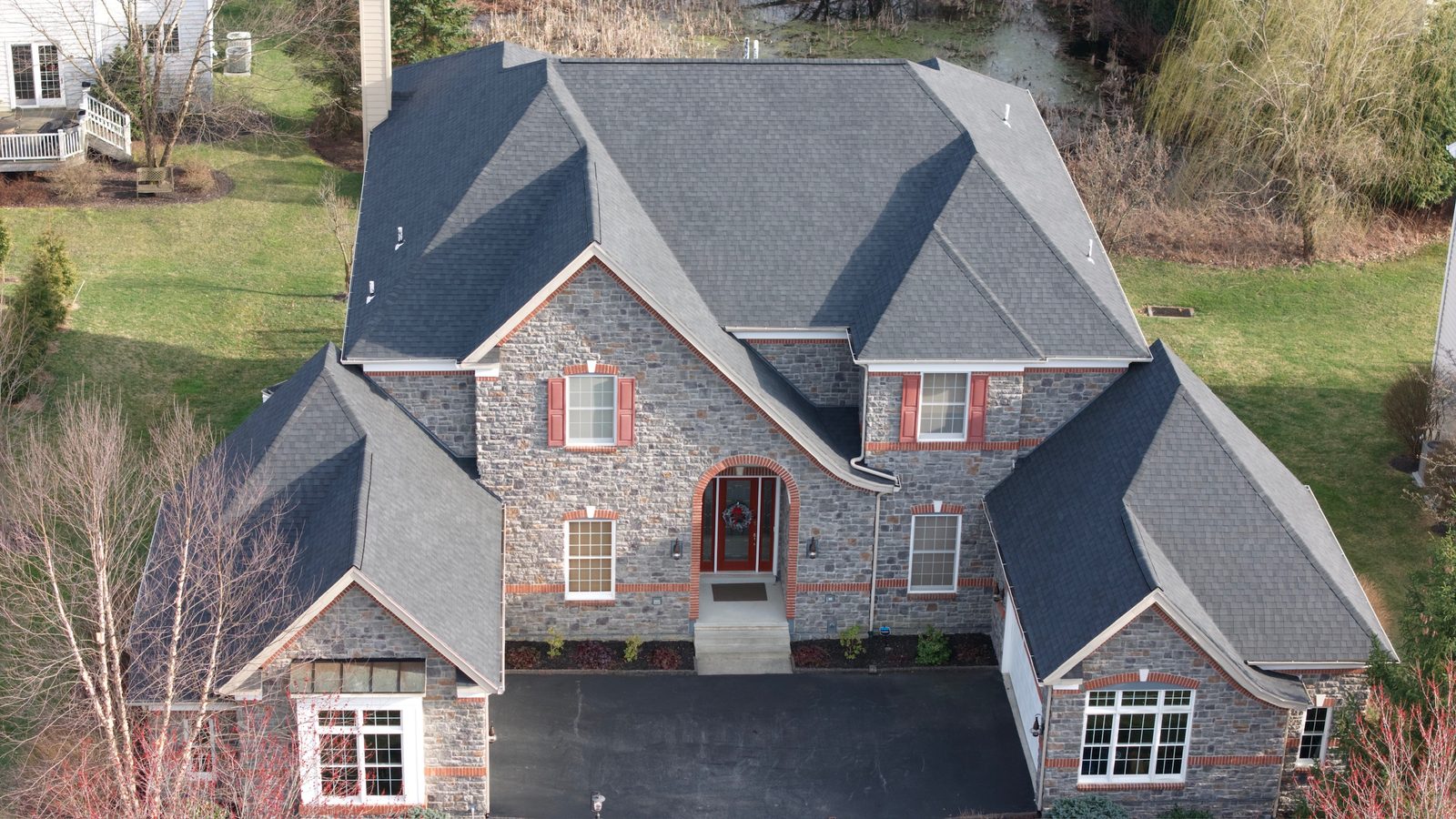 Large stone and brick home roof in West Chester, PA