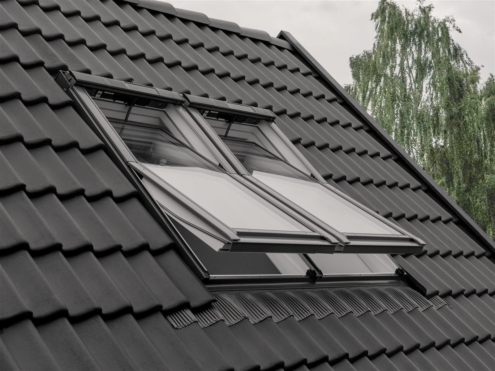Attic bedroom filled with daylight from VELUX skylights