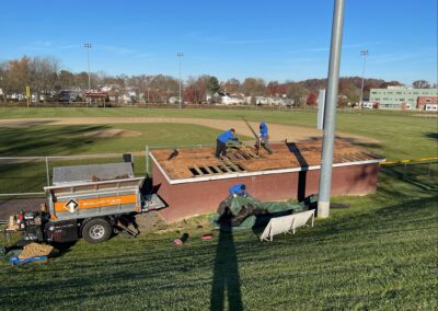 Team roofing local baseball dugout