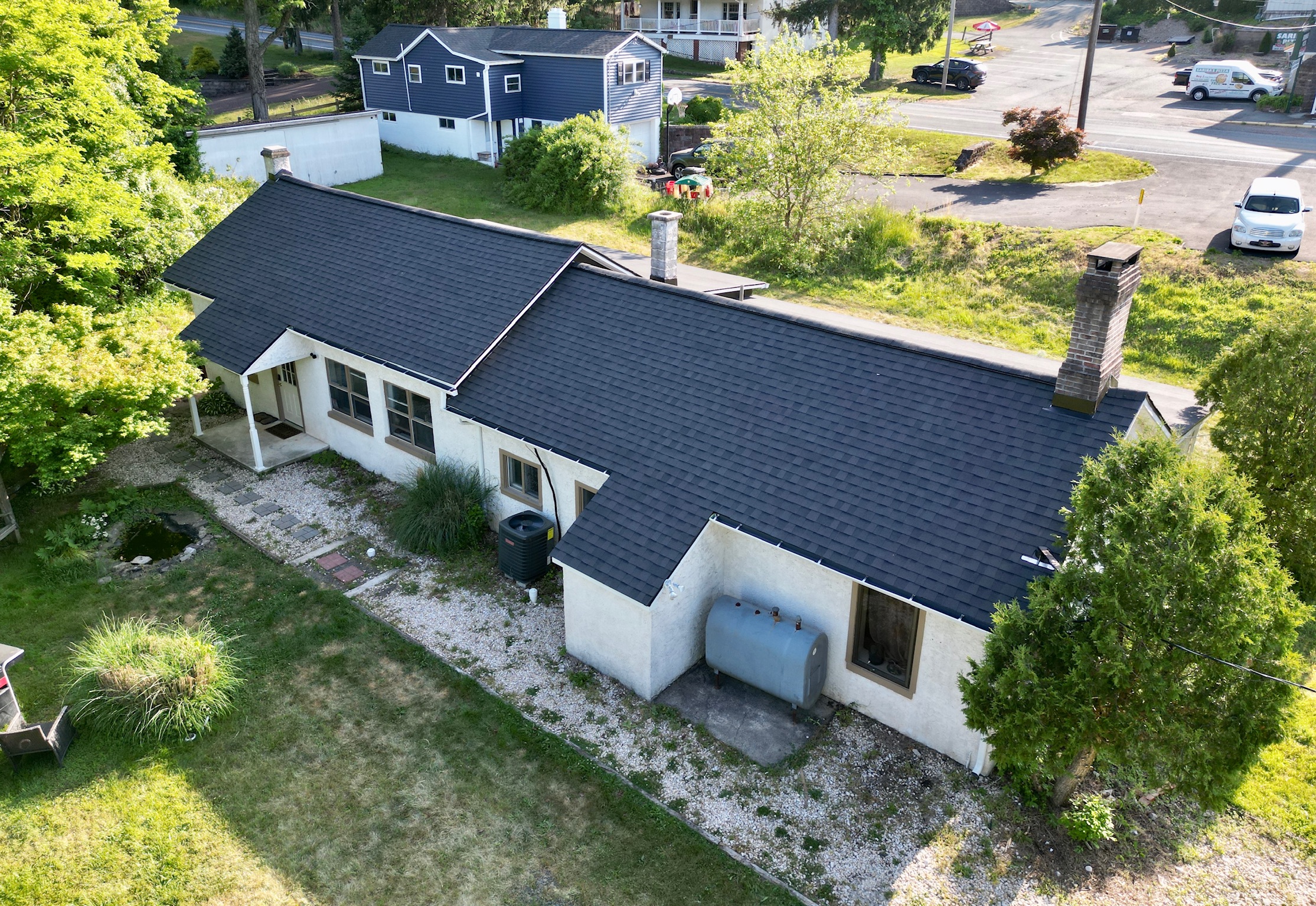 Image of backside of home with newly shingled roof 