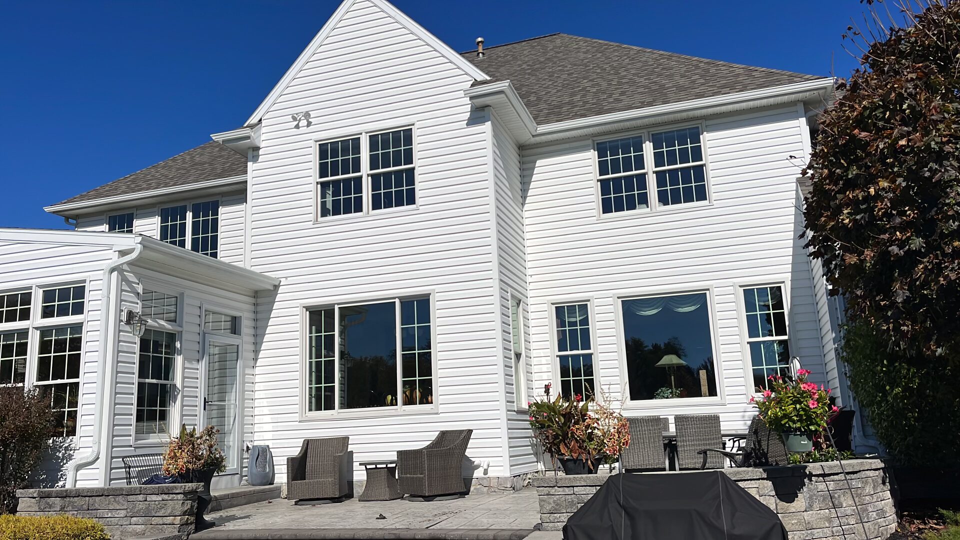 Shot of back of home with new white siding 