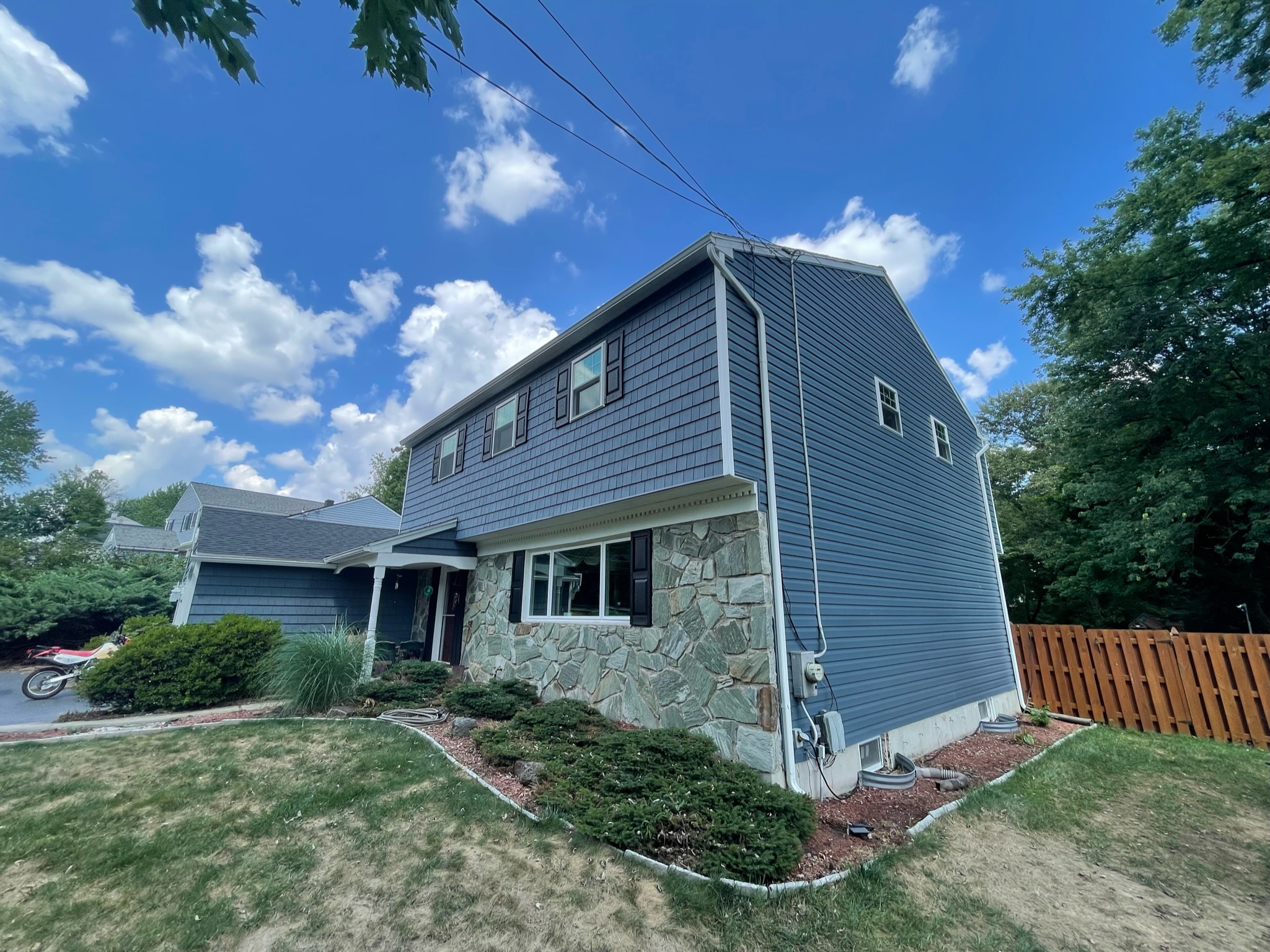 Side shot of home with new blue siding